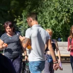 Фото татуировки на руке мужчины: детализированный рисунок, включающий в себя череп, цветы и другие элементы в черно-серых тонах. Реалистичный стиль татуировки.