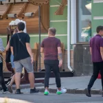 Фотография татуировки на руке мужчины, выполненной в виде тонких черных линий, образующих абстрактный узор. Татуировка выглядит стильно и современно.