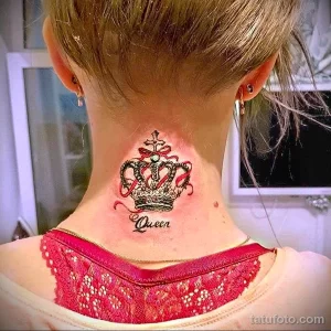 Фотография татуировки короны с надписью "Queen" на шее женщины. Цветная татуировка с использованием розовых и красных оттенков.