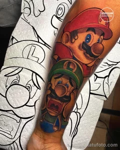 Фото тату на руке: красочное изображение Марио и Луиджи из игры Super Mario Bros, выполненное в стиле мультфильма.