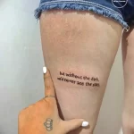 Фото минималистичной татуировки на ноге с надписью 'but without the dark, we'd never see the stars'. Тонкая, изящная работа.