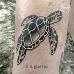 Фото тату черепахи, выполненной в стиле blackwork с использованием только черных чернил. Простой и элегантный рисунок татуировки на руке.