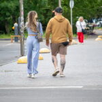 Фото тату на икре мужчины: реалистичный рисунок розы с листьями в черно-серых тонах. Детализированная проработка лепестков и стебля.