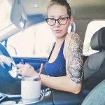 Фото татуировки в виде рукава на руке, с изображением черепов, звезд, геометрических фигур и других мистических символов. Черно-серая татуировка с высокой детализацией.