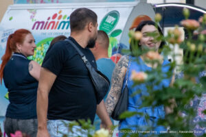 Фото тату на руке: детализированный черно-серый рисунок черепа, окруженного цветами, выполненный в графическом стиле.