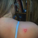 Маленькая красная татуировка с сердечком на правой лопатке девушке - tatufoto.com 10022023 - 009