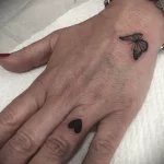 Маленькая татуировка с чёрным сердцем на безымянном пальце женщина - tatufoto.com 10022023 - 012