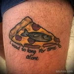 Фото тату кусочка пиццы с рыбой, плавающей на нем, и надписью 'I used to long for time alone'. Необычный и философский эскиз тату.