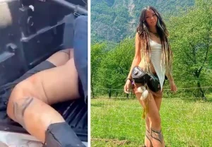 Фотография девушки с татуировкой на ноге, стоящей на фоне живописной природы, демонстрирующая гармонию с окружающим миром.