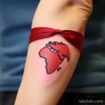 A tattoo of a red ribbon forming a globe for HIV awa e ee d a efb _1 231123 tatufoto.com