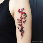 A tattoo with a puzzle piece connecting to a ribbon faefb b ea bdfdefa _1_2 231123 tatufoto.com