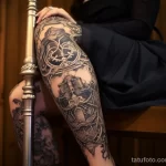 A woman with a large, intricate garter tattoo on her thigh, elegantly dressed for a night out 5 - 07,11,2023 tatufoto.com