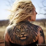 A woman with a stunning tattoo of a lion across her back, captured while on a safari adventure 5 - 07,11,2023 tatufoto.com