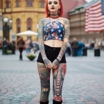 American beautiful Girl in full growth on the city square with cool tattoos on her body posing dressed in short national clothes 5 - 08112023 tatufoto.com 48