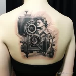 Artistic tattoo of a vintage movie projector on someone's shoulder_3 16.11.2023 tatufoto.com 04
