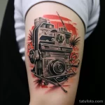 Detailed tattoo of a camera with a film strip from 'Cinema Paradiso' on a bicep 1_3 16.11.2023 tatufoto.com 24