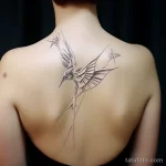 . Origami crane in flight on shoulder blade 16.11.2023 tatufoto.com 032