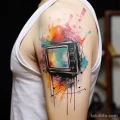 Tattoo of a broken TV screen with colorful splashes faf e f b bbacebee _1 181123 tatufoto.com