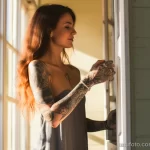 beautiful woman with tattoos is demonstrating long-term care for tattooed skin 4 09112023 tatufoto.com 066