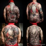 уник тату фото Large detailed tattoo of Santa Claus on the back, depicting him in full height with a bag of gifts 2 13.11.2023 tatufoto.com 15