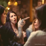A person pointing to their tattoo while telling a st aa a c feafcb _1 161223 tatufoto.com 036
