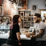 Client asking questions in a tattoo studio styliz ac f bc da dbadf 051223 tatufoto.com