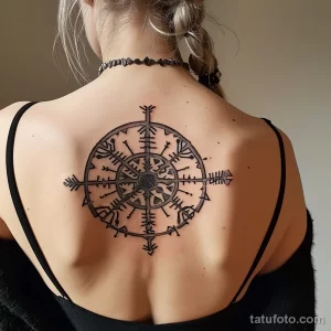 Фото тату: простой и элегантный Вечный Компас в стиле blackwork на женской спине. Геометрический эскиз тату с тонкими линиями.