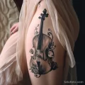 Рисунок тату с виолончелью - The cello tattoo on her thigh peeked out from her fl adf d b cfcfae _1_2_3 - 291223 tatufoto.com 248