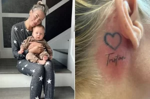 Фото татуировки в виде сердца с надписью 'Tristan' за ухом у девушки, держащей ребенка.