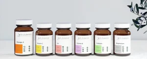 Рекламное фото витаминов Dr. Zubareva: шесть банок с различными витаминами (Omega-3, Vitamin C, Iron, Vitamin B, Probiotic, Magnesium) на белом фоне.