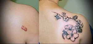 Фото тату ветки цветущей сакуры, покрывающей шрам на плече. Деликатный и красивый рисунок татуировки в японском стиле.