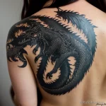 close-up of a black ink dragon tattoo on a woman’s back, tatufoto.com 294