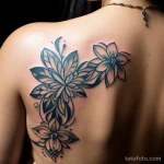 close-up of a woman’s back tattoo, beautifully aging over time tatufoto.com 103