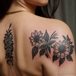 delicate floral tattoo on a woman’s shoulder, black ink, close-up tatufoto.com 273