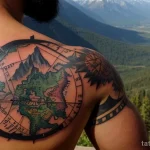 strong man with a compass and map tattoo on his back, symbolizing adventure, looking out over a scenic mountain view tattoo lion tatufoto.com 204