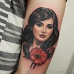 young woman with a tattoo on her forearm, holding a flower tatufoto.com 153