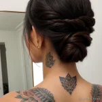 young woman with a tattoo on her neck, reflecting in the mirror tatufoto.com 221