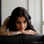 young woman with a tattoo, reflecting on her past choices tatufoto.com 243