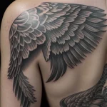 Татуировки эскортниц - A close-up of angel wings tattooed on a woman's shoulder blades, highly detailed, ultra-realistic, 8K resolution, intricate tatt tatufoto.com 029