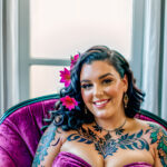 Как вес влияет на тату A plus-size woman with a colorful chest tattoo lounging on a velvet armchair wearing a strapless dress dark curly hair pinned tatufoto.com 033