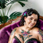 Как вес влияет на тату A plus-size woman with a colorful chest tattoo lounging on a velvet armchair wearing a strapless dress dark curly hair pinned tatufoto.com 034
