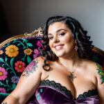 Как вес влияет на тату A plus-size woman with a colorful chest tattoo lounging on a velvet armchair wearing a strapless dress dark curly hair pinned tatufoto.com 100