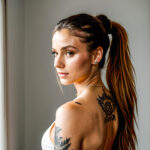 Как вес влияет на тату A slender woman with a minimalist moon tattoo on her neck standing in a dimly lit room wearing a high ponytail tattoo blendin tatufoto.com 157