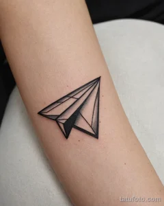 close up, a minimalist tattoo of a paper airplane №33 - tatufoto.com