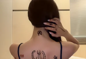 Giselle Aespa with tattoos on the back of her neck and head
