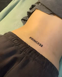 Татуировка надпись 'PRINCESS$$$' на пояснице