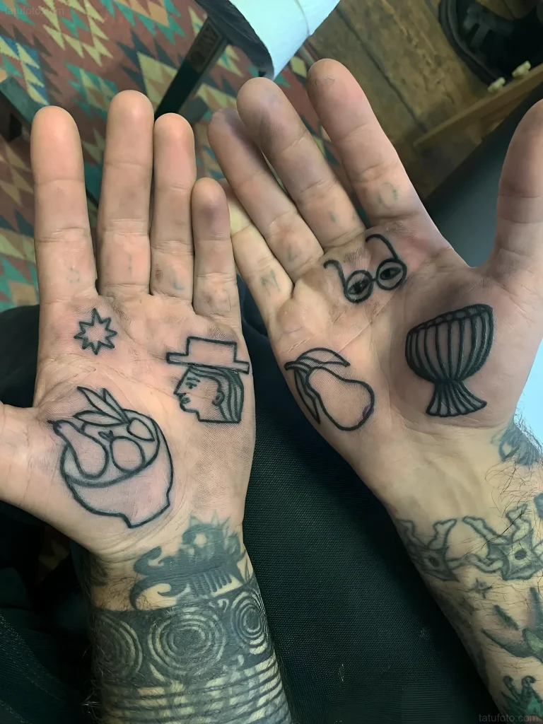 双手纹身照片:星星、戴帽子的头、胜利手势、眼镜和鼓,采用极简图形风格绘制。