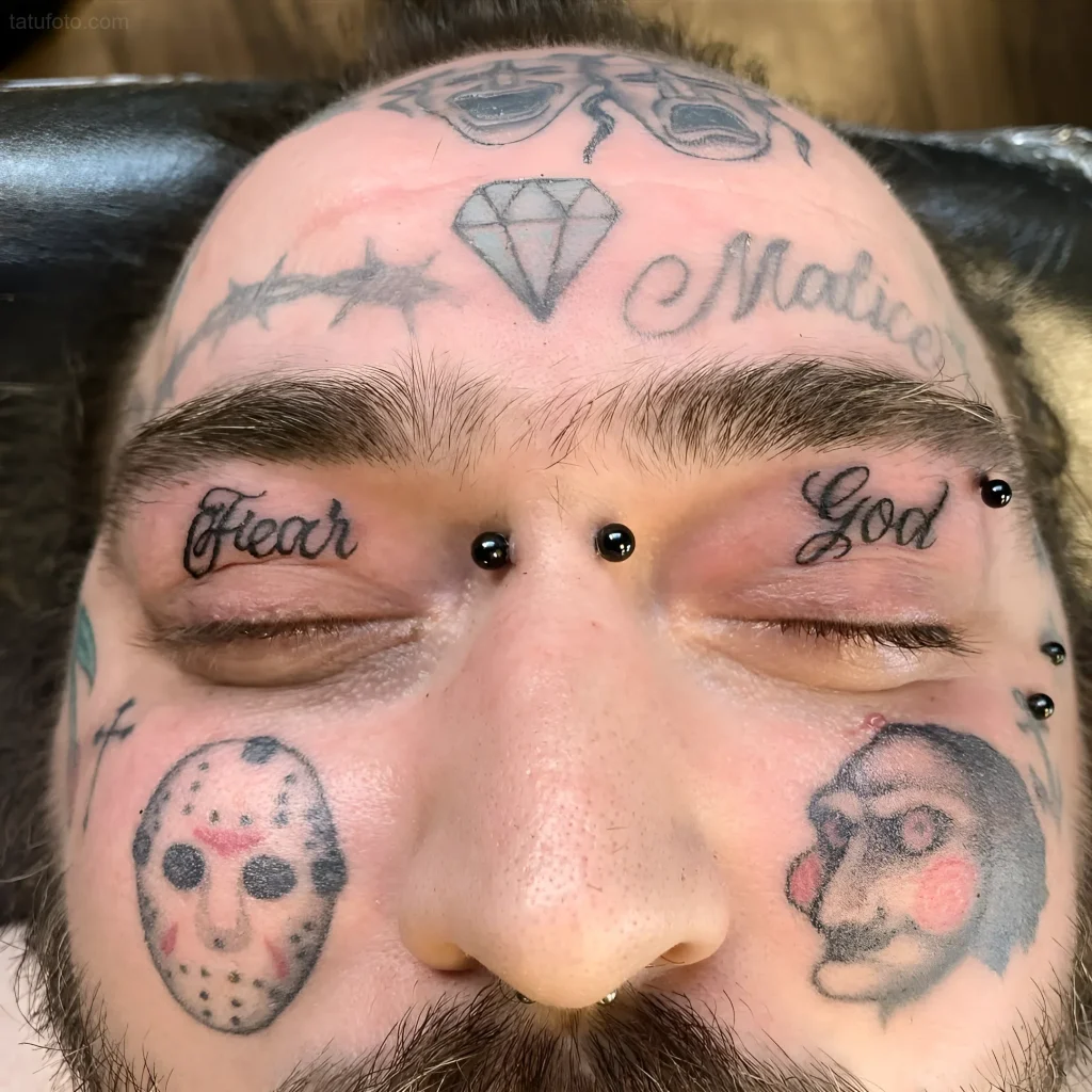Photo of tattoos on the face and eyelids: 'Fear God' inscriptions, Jason Voorhees mask, diamond, and other elements in a bold combination.