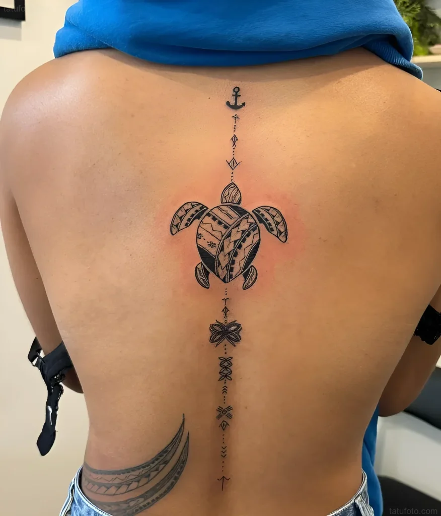 Black and white tattoo along the spine depicting a sea turtle, anchor, butterfly, and wave in minimalist style.