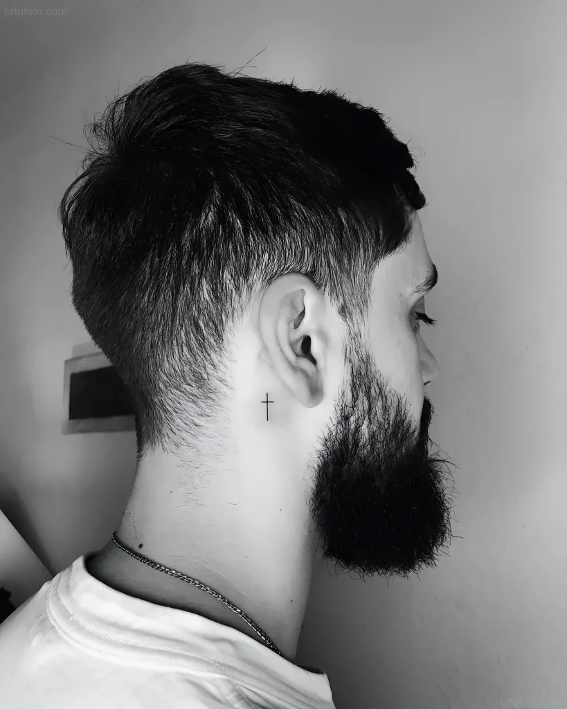 黑白照片,一名留着整洁发型和胡须的男士,耳后皮肤上纹有一个小十字架,采用细线技术.
